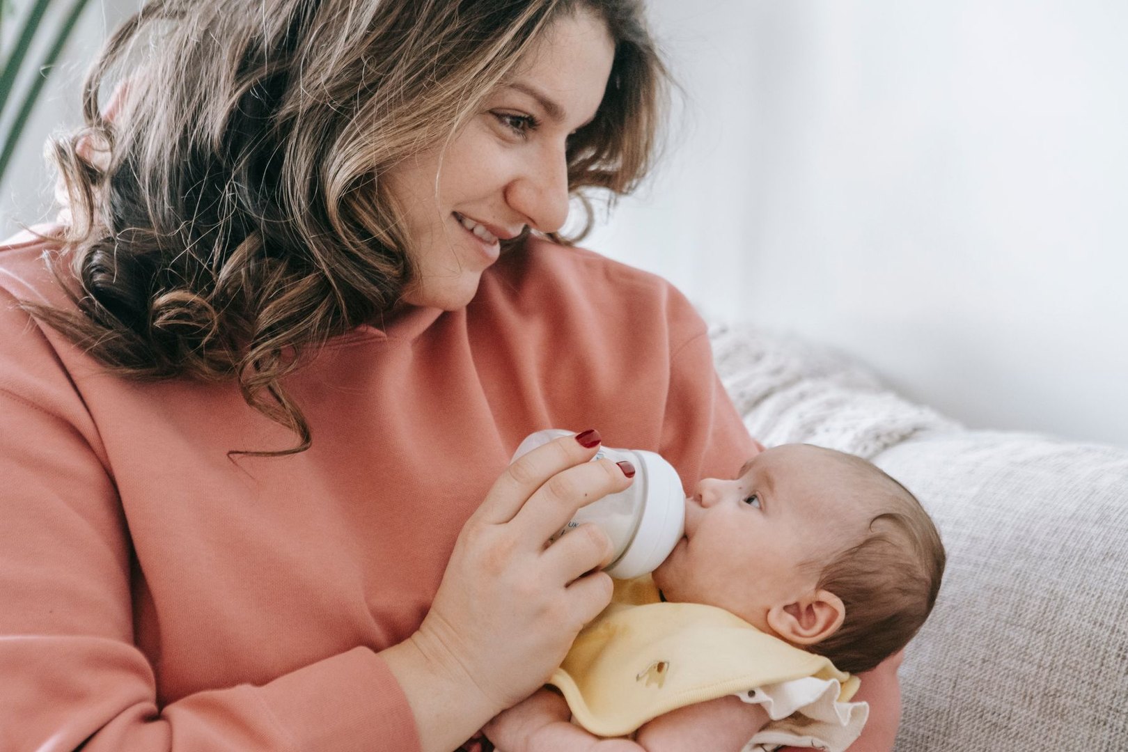 A mother bottle-feeding her baby