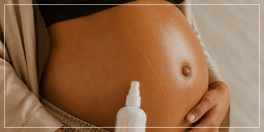 Mom with maternity bump oil, mother essentials