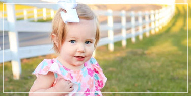 Smiling baby in a floral outfit, baby and kids clothing