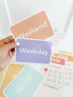 Colorful calendar flashcards and magnets for early learning, showcasing days, months, and seasons in a playful design.