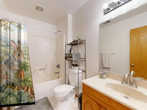 Bunny Garden Farm shower curtain on a tub shower combo in an American family bathroom