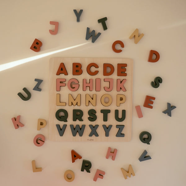 Wooden alphabet puzzle in vibrant colors, showcasing letters at an angle for engaging early learning play.