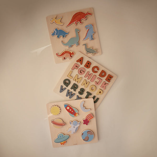 Colorful wooden dino puzzle from an angle, perfect for toddlers' play and learning.