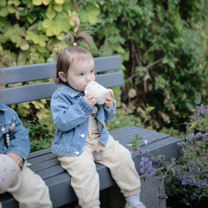 Silicone training cup with straw at a 44-degree angle, perfect for toddlers learning to drink independently.