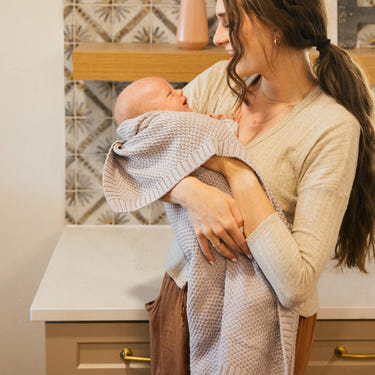 Soft thistle knitted swaddle blanket for babies, perfect for cozy comfort and warmth.