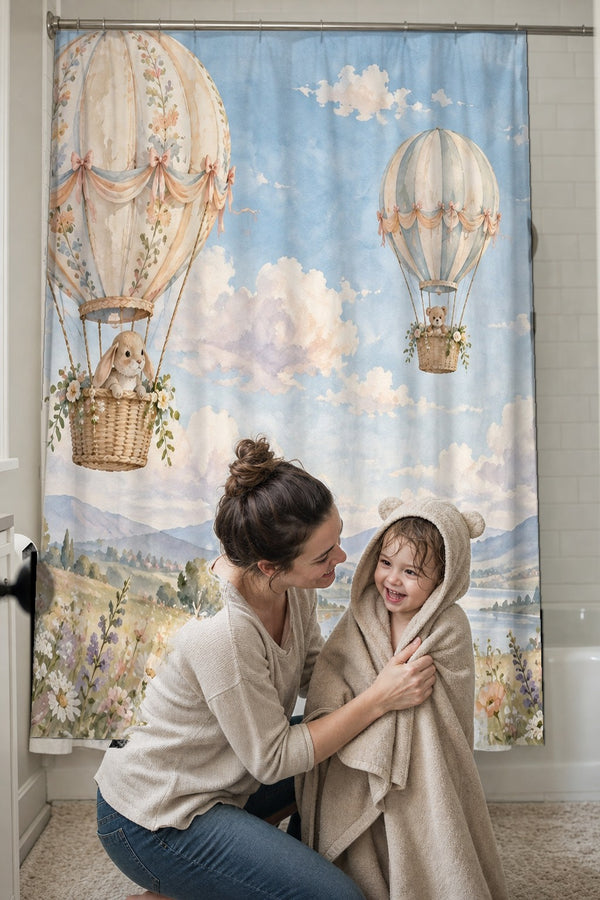 Mom drying her toddler in a hooded towel in front of the Meadow Hot Air Balloons shower curtain