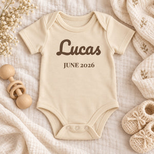 Styled flat lay of the Name and Birth Month baby bodysuit
