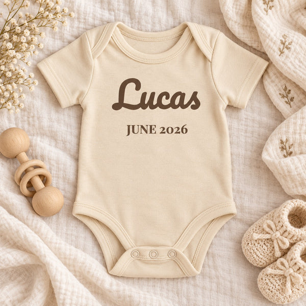 Styled flat lay of the Name and Birth Month baby bodysuit
