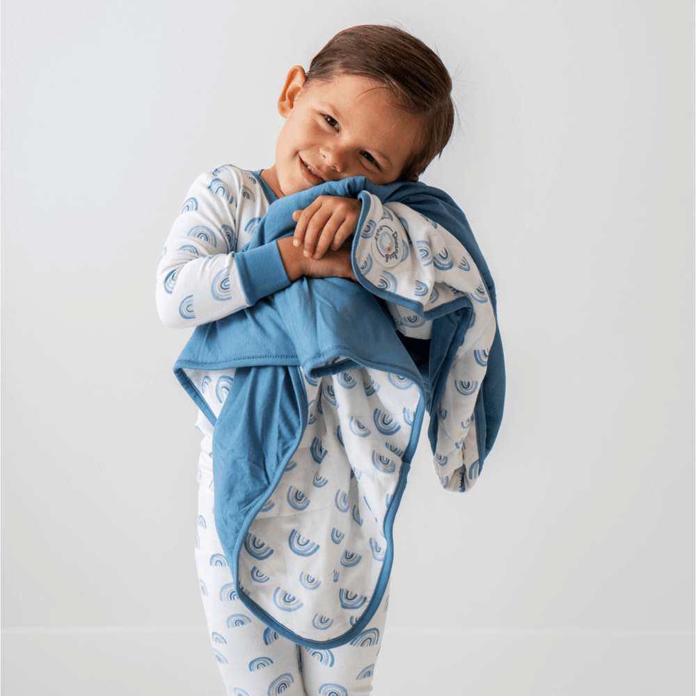 Blue rainbow bamboo pajamas for toddlers and kids, soft and eco-friendly sleepwear.
