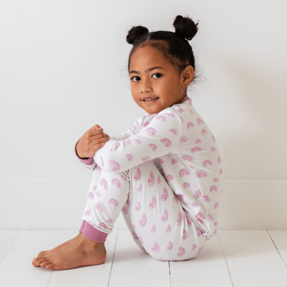 Pink rainbow bamboo pajamas for toddlers and kids, soft and eco-friendly sleepwear.