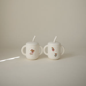 Silicone training cup with straw at angle 68, perfect for toddlers learning to drink independently.