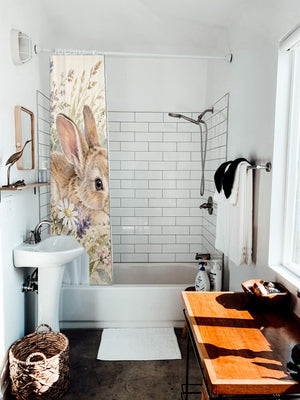 Lavender Bunny shower curtain hanging on the rod over a white bathtub