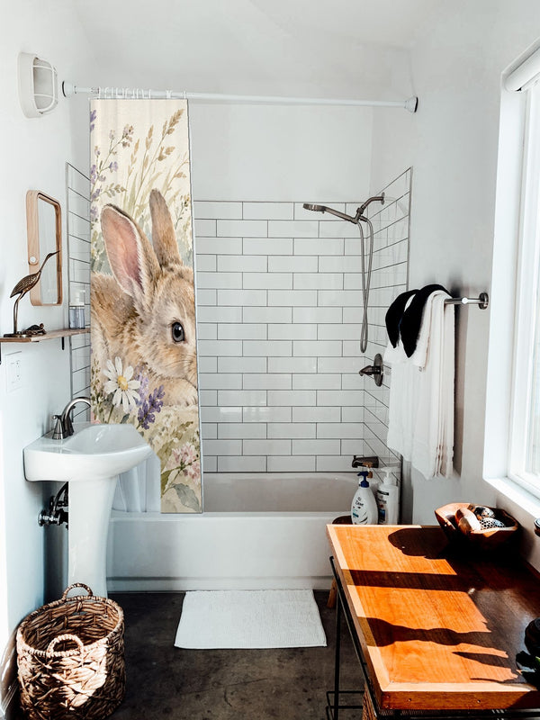 Lavender Bunny shower curtain hanging on the rod over a white bathtub