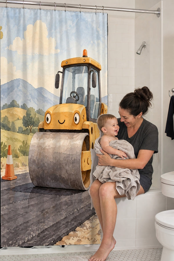 Mom holding her baby on the tub edge next to the Road Roller shower curtain