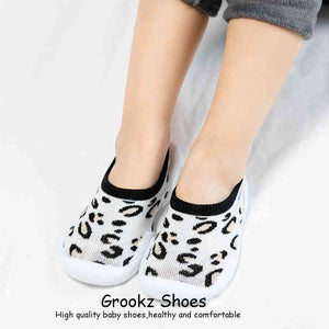 White leopard baby sock shoes from angle 7, perfect for stylish comfort and warmth for little feet.