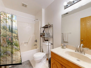 Peaceful Garden Bunny shower curtain on a tub shower combo in an American family bathroom
