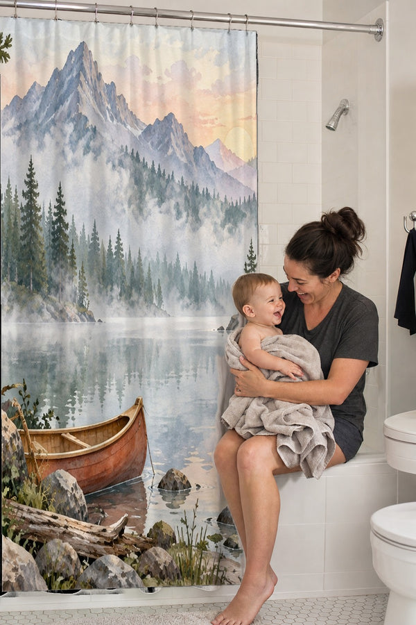 Mom holding her baby on the tub edge next to the Canoe Lake Camping shower curtain