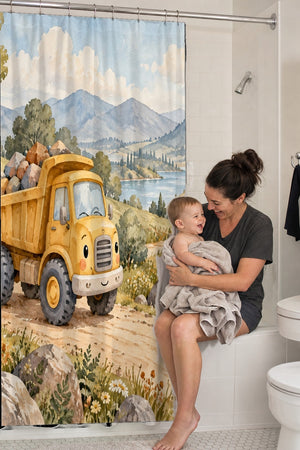 Mom holding her baby on the tub edge next to the Dump Truck Road shower curtain