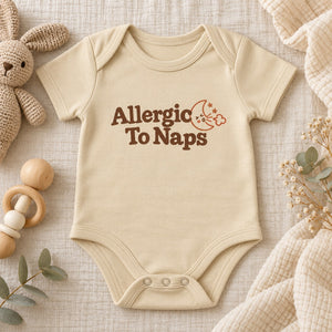 Styled flat lay of the Allergic To Naps baby bodysuit