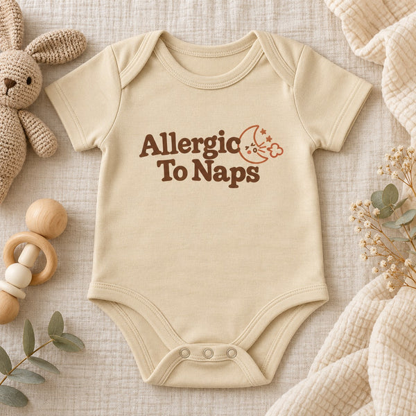 Styled flat lay of the Allergic To Naps baby bodysuit