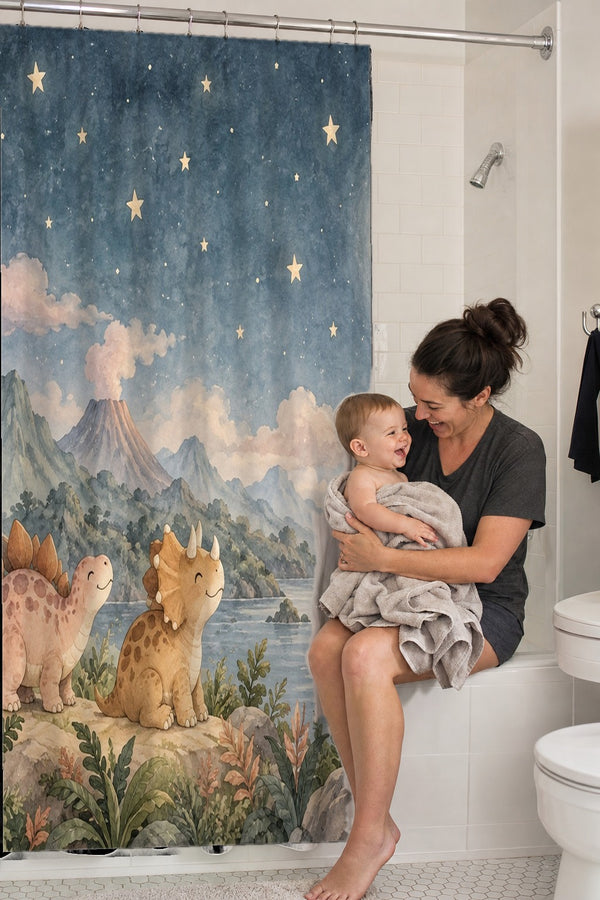 Mom holding her baby on the tub edge next to the Moonlit Dinosaurs shower curtain