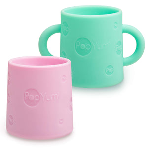 PopYum Silicone Training Cup 2-Pack in mint green and pastel pink, BPA free, perfect for baby self-feeding.