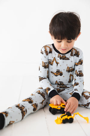 Dream Digger Set sleepsuits and pyjamas for babies, featuring a playful design in a cozy angle view.