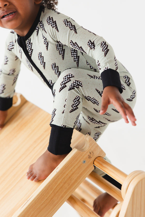 "Strike All Night Zippy baby sleep sack in cozy bedding, angle 3 view showcasing soft fabric and secure design."