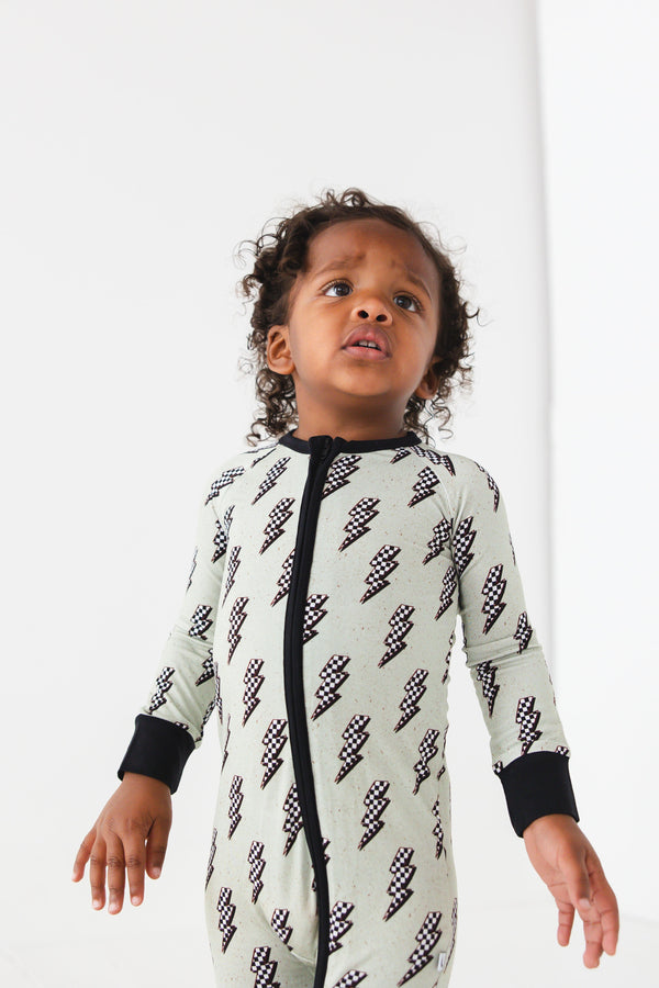 "Strike All Night Zippy baby sleep sack in cozy bedding, angle view showcasing soft fabric and secure design."