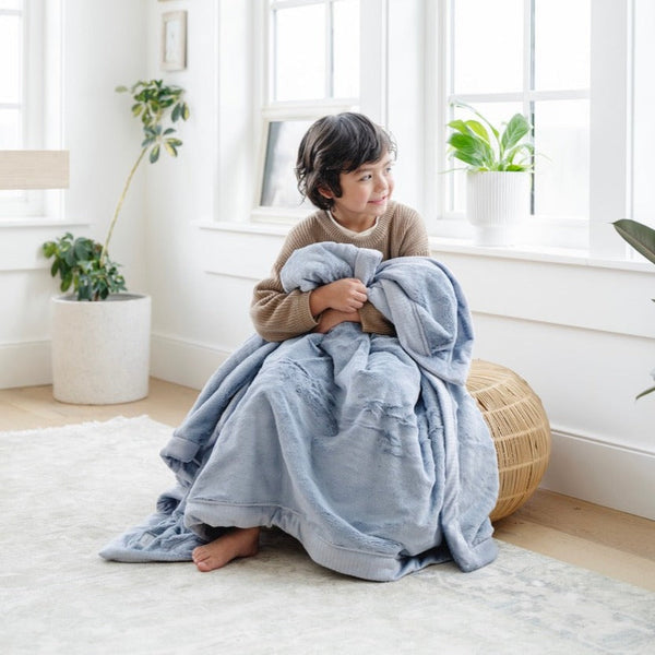Lush toddler blankets in soft colors, perfect for cozying up or swaddling your little one.
