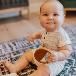 Sage Sunburst Teething Toy at angle 10, perfect for soothing baby's gums during teething.