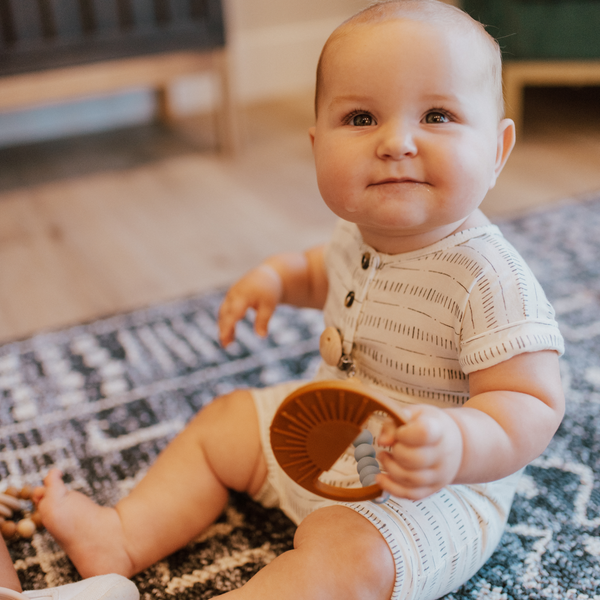 Sage Sunburst Teething Toy at angle 10, perfect for soothing baby's gums during teething.