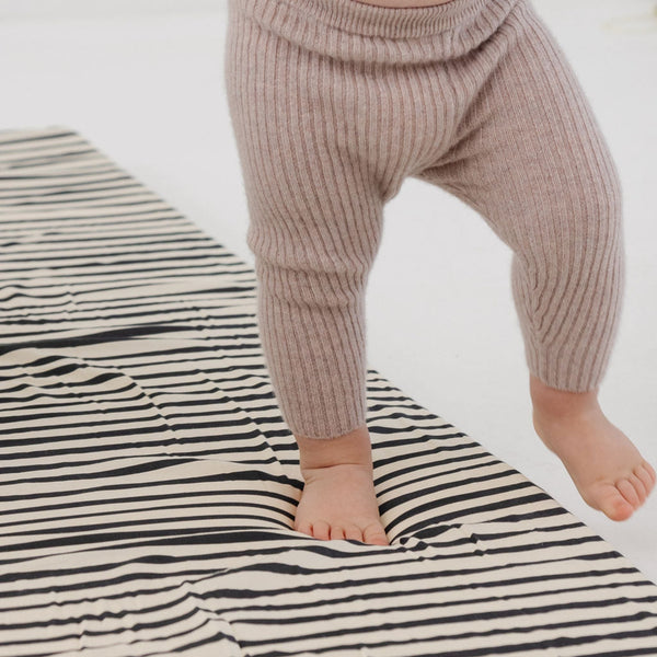 Bold Stripe Organic Cotton Mat at a 15-degree angle, perfect for baby playtime and eco-friendly comfort.