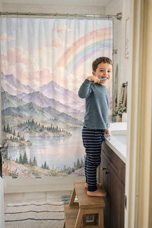 Child brushing teeth in a family bathroom with the Lavender Peaks Rainbow shower curtain