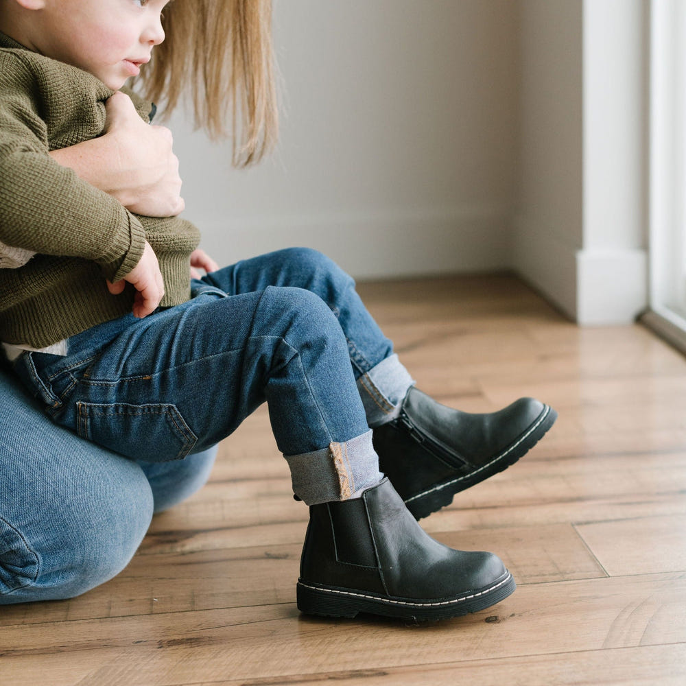 Black Chelsea boot with hard sole for babies, stylish and durable footwear for little ones.