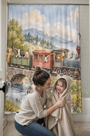 Mom drying her toddler in a hooded towel in front of the Countryside Train shower curtain