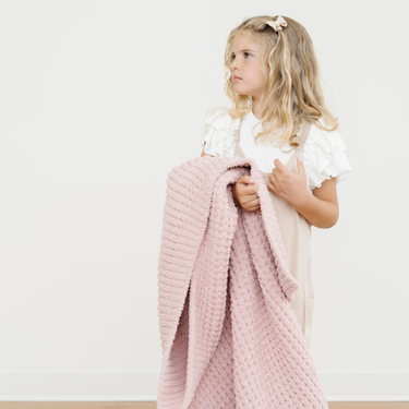 Waffle knit toddler blankets in soft colors, perfect for cozying up and snuggling. Ideal for blankets and swaddles.