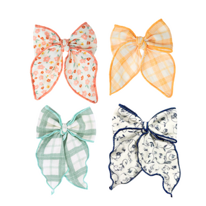 Fable Bow in Fern Plaid, mid-size accessory for babies, shown from angle 2. Perfect for seasonal wear.