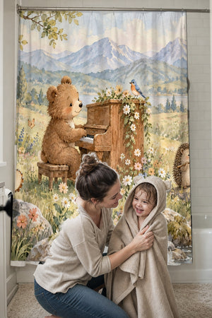Mom drying her toddler in a hooded towel in front of the Bear Piano shower curtain