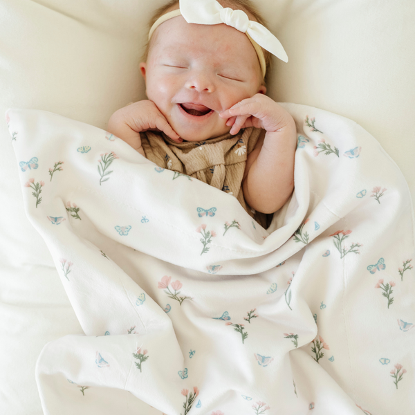 Soft Minky Stretch Receiving Blankets in various colors, perfect for swaddling and keeping your baby cozy.