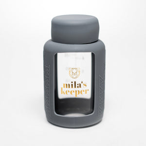 Set of 2 glass breast milk bottles, angled view, perfect for safe breast milk storage.