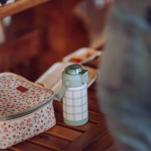 Sip + Chug 2 in 1 Thermo Water Bottle 12 oz. in Fern Plaid, angled view showcasing its stylish design and functionality.