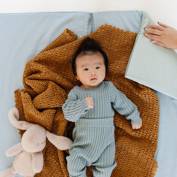 Sage + Breeze Organic Cotton Play Mat in angle view, showcasing soft, eco-friendly design for babies.
