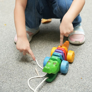 Colorful Rainbow Alligator toy for babies, promoting fun and imaginative play in a vibrant design.