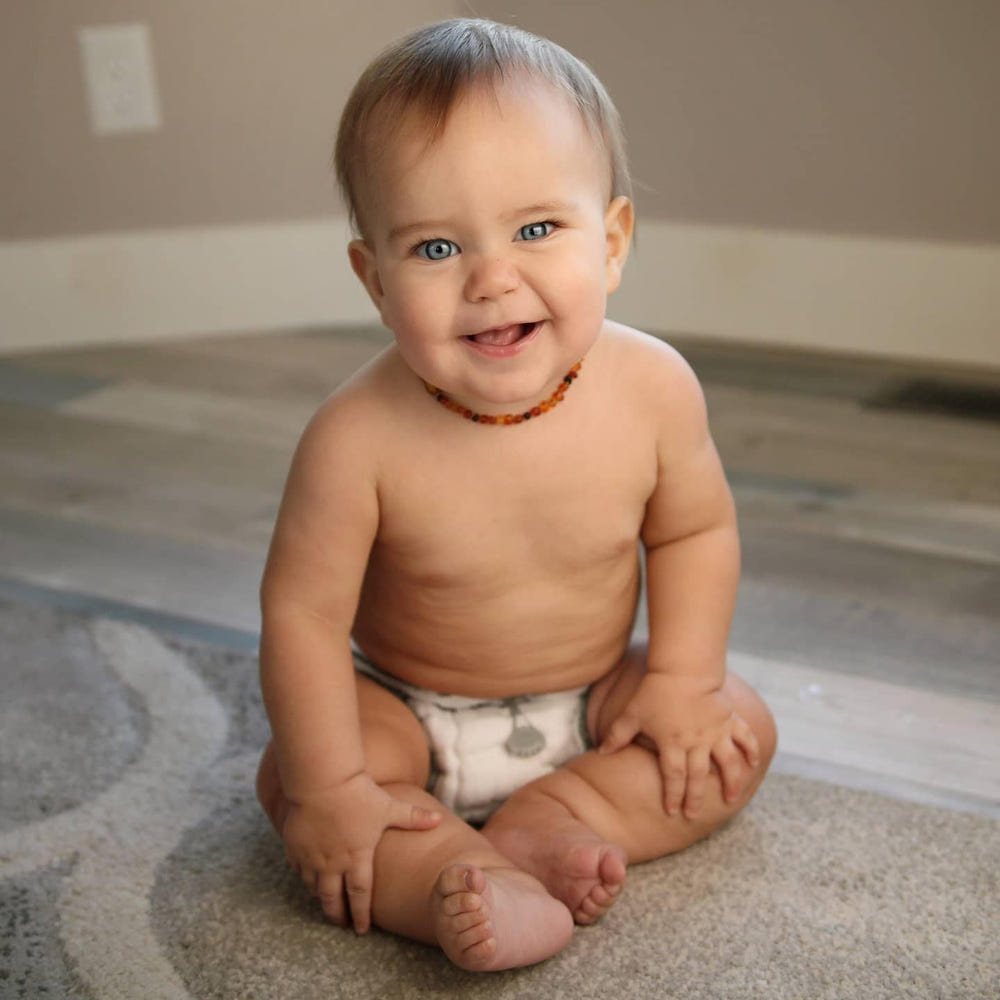 Cotton fitted cloth diaper without snaps, soft and absorbent, perfect for eco-friendly baby care.
