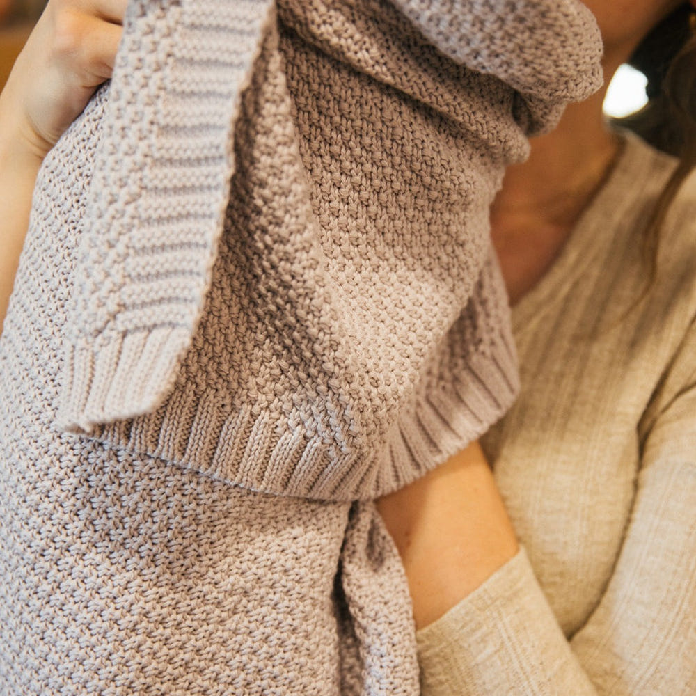 Soft thistle knitted swaddle blanket for babies, perfect for cozy comfort and warmth.