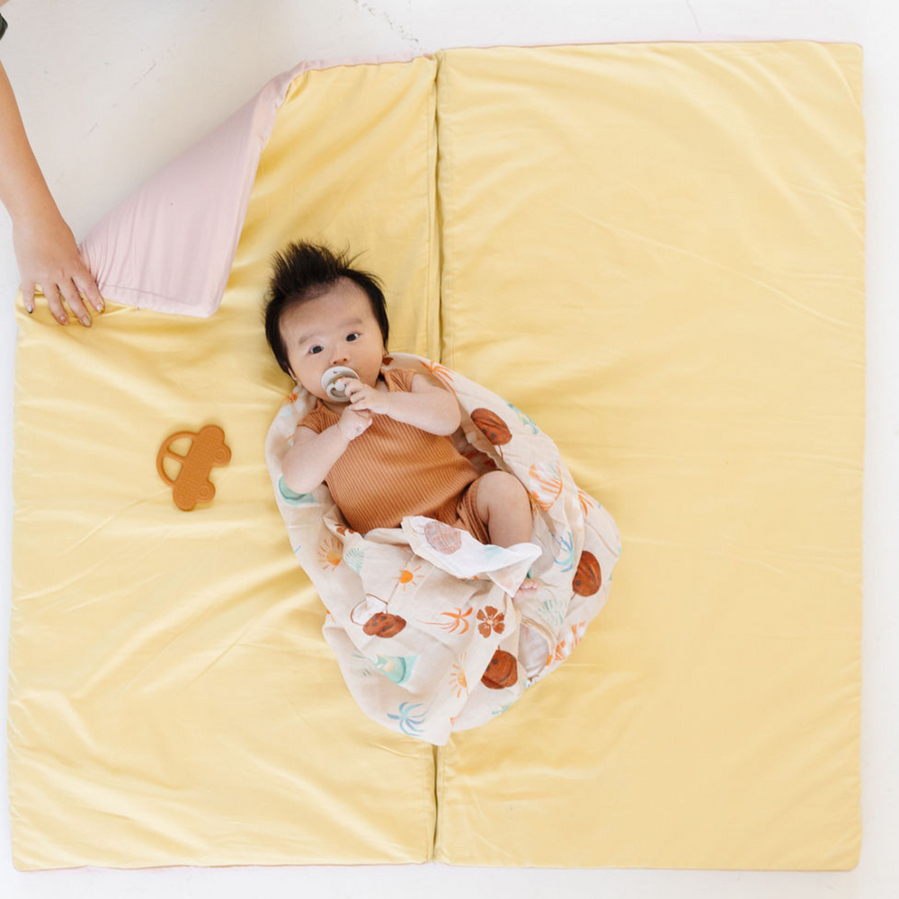 Tutu + Daisy Organic Cotton Play Mat for babies, featuring a soft, colorful design perfect for playtime and tummy time.