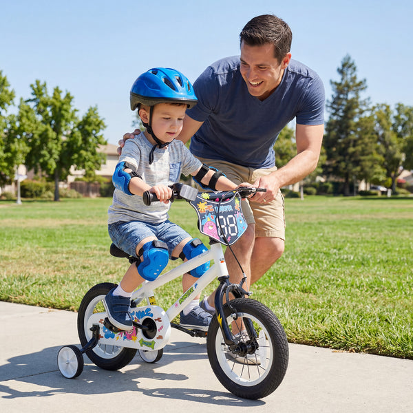 12-inch kids bike with training wheels for ages 3-4, featuring street art design in white, angled view.