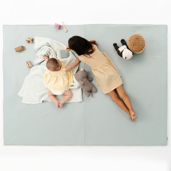 Sage Vegan Leather Play Mat for babies, stylish and soft, shown from angle 12. Perfect for playtime and tummy time.