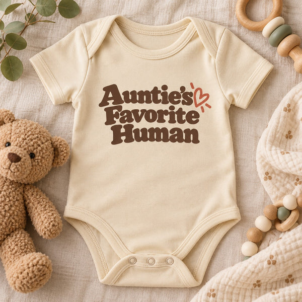 Styled flat lay of the Auntie's Favorite Human baby bodysuit